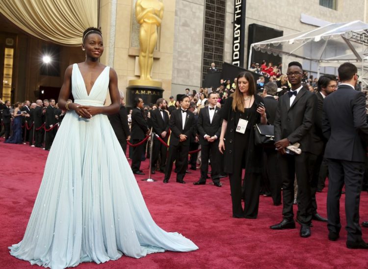  Lupita Nyong'o in a pale blue Prada dress at the 2014 Oscars in Los Angeles. 