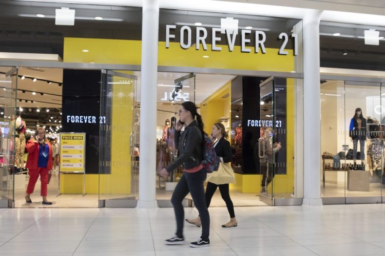 People walk in front of a Forever 21 clothing store in New York in September. 
