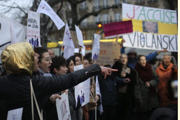 Women demonstrate against multiple nominations for Roman Polanski outside the Cesar awards ceremony, the French equivalent of the Oscar, Friday in Paris. The poster at right reads, "I accuse Violanski," playing withe French word for rape and the name Polanski.