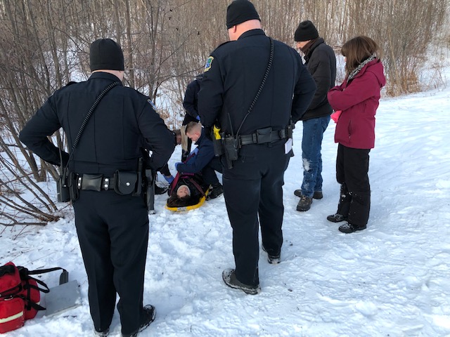 Emergency workers tend to a woman injured Saturday while sledding at Quarry Road Recreation Area in Waterville.

