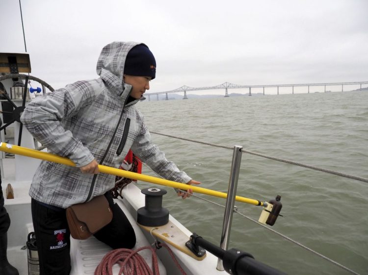 Alice Zhu, with the University of Toronto, prepares to take a sample of water from San Francisco Bay in 2017. The San Francisco Estuary Institute found microplastics in stormwater runoff entering the Pacific Ocean in a three-year study completed in 2019.