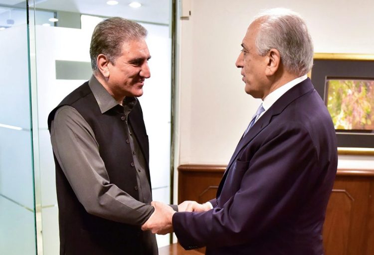 Pakistan's Foreign Minister Shah Mehmood Qureshi, left, meets U.S. envoy Zalmay Khalilzad at the Foreign Ministry in Islamabad, Pakistan, on Friday. Khalilzad has met with Pakistan's foreign minister to find a peaceful solution to neighboring Afghanistan's war. 