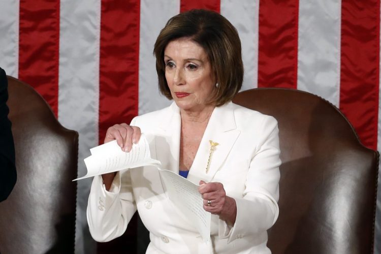 House Speaker Nancy Pelosi tears her copy of President Trump's State of the Union address after he delivered it to a joint session of Congress on Tuesday night.