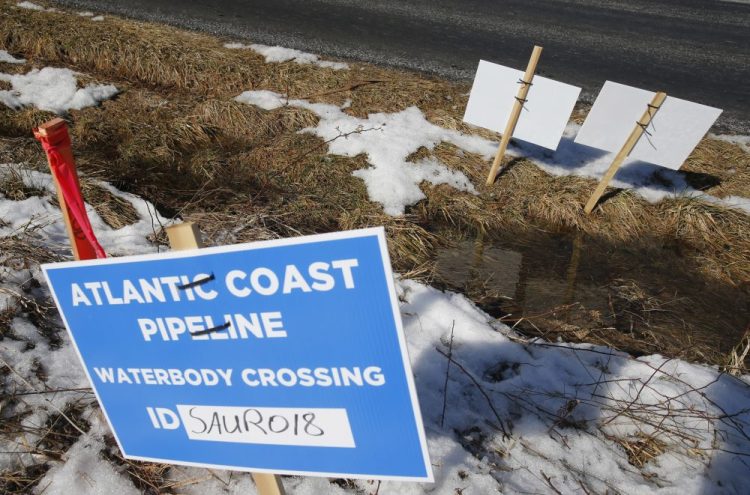 Signs mark the route of the Atlantic Coast Pipeline in Deerfield, Va. The U.S. Supreme Court has ruled 7-2 to reverse a lower court ruling that had thrown out the permit for the pipeline.
