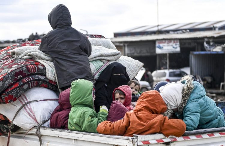 Civilians flee from Idlib toward the north to find safety inside Syria near the border with Turkey on Saturday. Syrian troops are waging an offensive in the last rebel stronghold. 