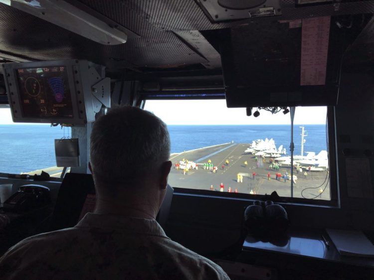 Marine Gen. Frank McKenzie, top U.S. commander for the Middle East, watches flight operations Saturday on board the USS Harry S. Truman in the North Arabian Sea. Nearly a month after Iran launched a rare direct military attack against U.S. forces in Iraq, an uneasy quiet has settled across the region.