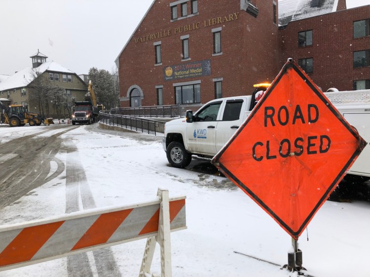 Workers with the Kennebec Water District repair a water main break Thursday morning on Appleton Street in downtown Waterville. The road next to the Waterville Public Library was closed for several hours.