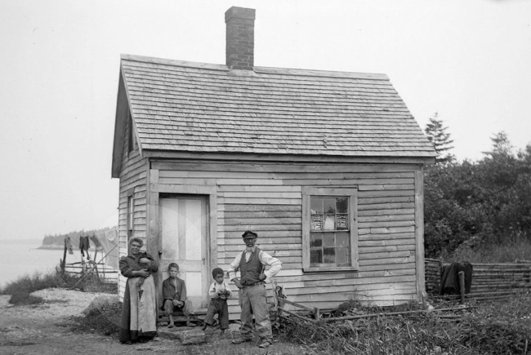 Rosella and John Eason with family in front of their home on Malaga Island in 1911.


