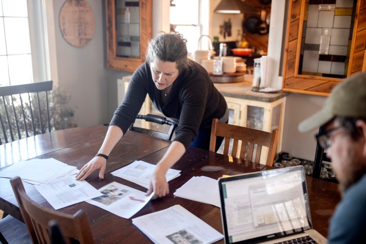 Writers Karl Schatz and Margaret Hathaway look over page drafts for the Maine Bicentennial Cookbook at their home, Ten Apple Farm. The cookbook, scheduled to come out in June, is one of many food and drinks efforts to celebrate the state's 200th birthday.