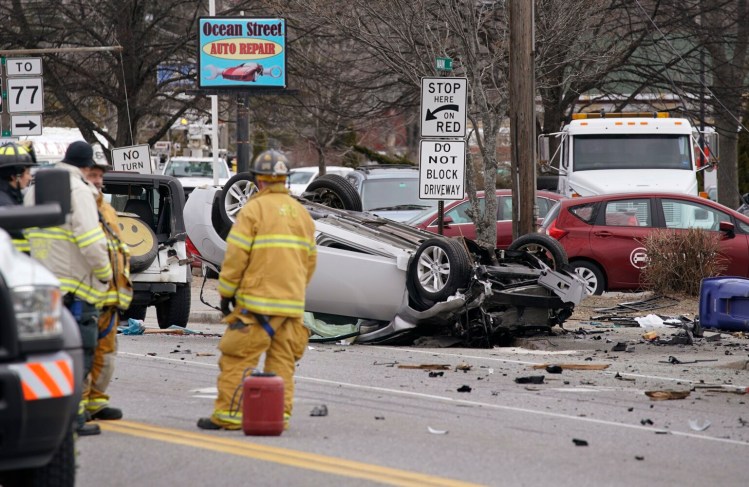 A Nissan Altima flipped and took out a utility pole on Main Street in South Portland on Thursday after being stolen by a man who robbed Town & Country Credit Union in South Portland, said police.