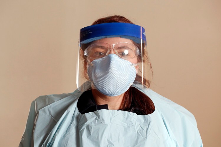 Kelly Mayo, a first-year student in Southern Maine Community College's fire science program who works in the Falmouth Fire-EMS Department, wears the protective gear that first responders wear in the age of COVID-19: a face shield, safety glasses, an N-95 mask, latex-free gloves and a protective gown. 