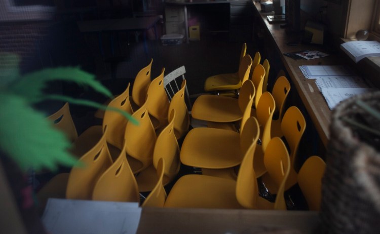 Students' chairs are stacked in a vacant classroom March 20 at Eight Corners Elementary School in Scarborough. Maine's education commissioner is advising school districts to plan to keep their classrooms closed for the rest of this academic year.