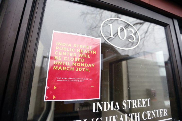 A sign at Portland's India Street Public Health Center informs patients that it is closed until March 30 after an employee has presumptively tested positive for COVID-19. 