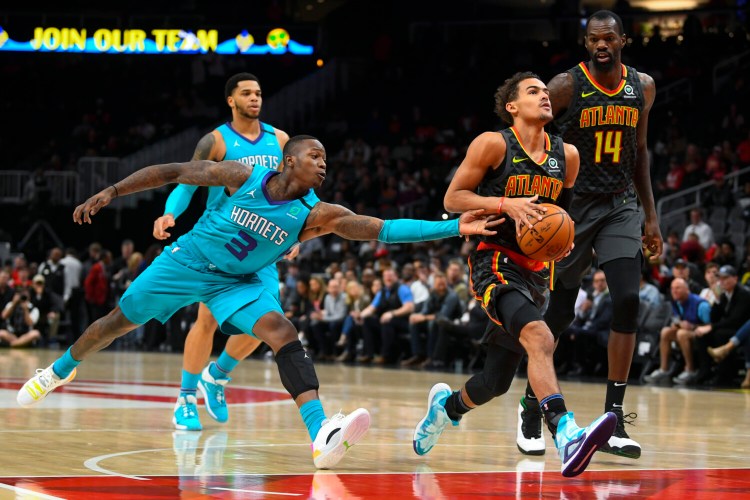 Atlanta Hawks guard Trae Young drives the lane as Charlotte Hornets guard Terry Rozier defends during the first half of the Hawks' 143-138 win in double overtime on Monday in Atlanta. Young had 31 points and 16 assists for Atlanta, while Rozier had 40 points for Charlotte. 