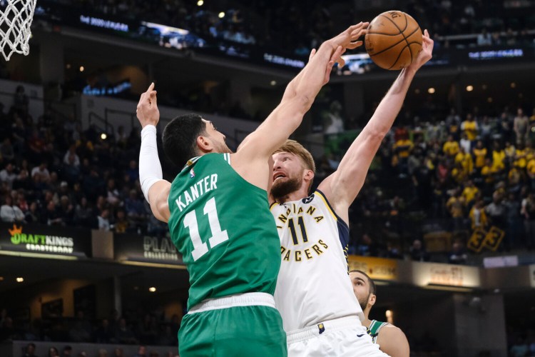 Indiana's Domantas Sabonis, right, tries to shoot around Boston center Enes Kanter during Tuesday's game in Indianapolis.