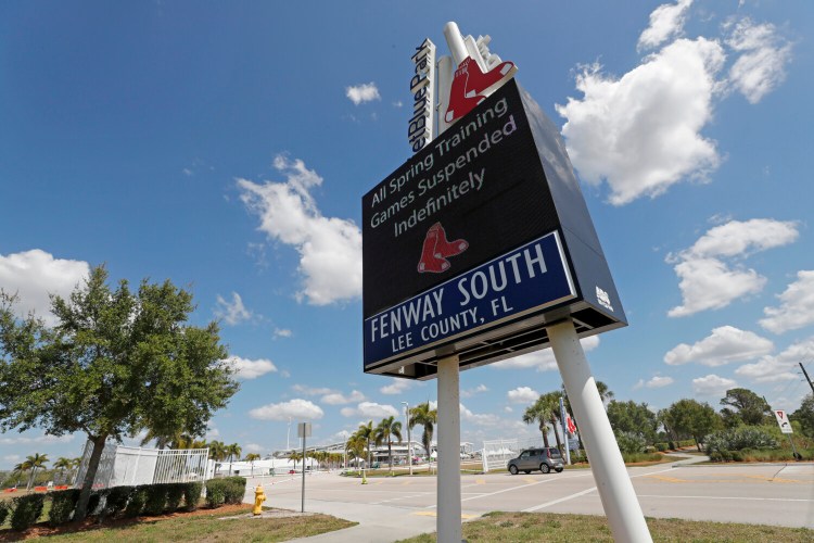 A sign announcing the suspension of spring training baseball games is displayed outside a closed JetBlue Park, the spring training home of the Boston Red Sox on Friday, in Fort Myers, Fla. Major League Baseball has suspended the rest of its spring training game schedule because of the coronavirus outbreak. The league is also delaying the start of its regular season by at least two weeks. 