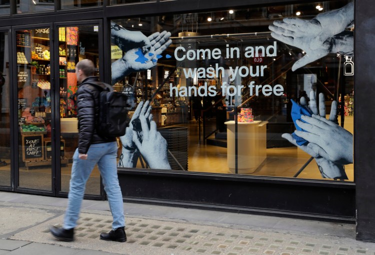 A shop offers free hand washing in London in March. Washing your hands is one simple step that will help prevent the spread of COVID-19.