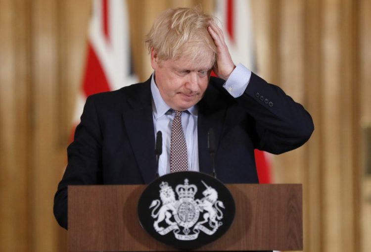 Britain's Prime Minister Boris Johnson reacts during a press conference at Downing Street on the government's coronavirus action plan in London, Tuesday, March 3, 2020. 