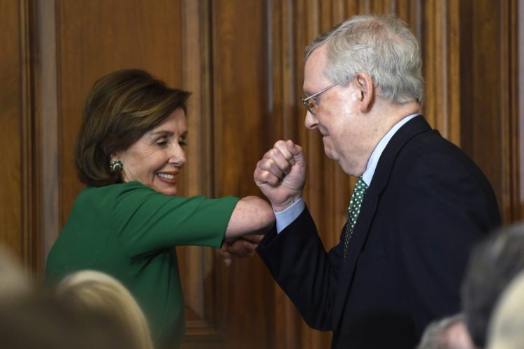 House Speaker Nancy Pelosi of Calif., left, and Senate Majority Leader Mitch McConnell of Ky., right, bump elbows Thursday as they attend a lunch with Irish Prime Minister Leo Varadkar on Capitol Hill in Washington.