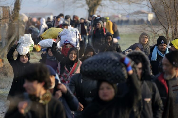 Migrants walk to reach Pazarakule border gate in Edirne, Turkey, at the Turkish-Greek border on Sunday.
