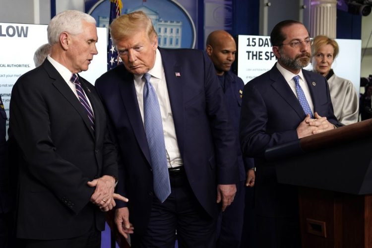 President Donald Trump listens to Vice President Mike Pence, left, as Health and Human Services Secretary Alex Azar speaks during a press briefing with the coronavirus task force, in the Brady press briefing room at the White House, Monday, March 16.