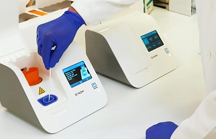 Abbott Laboratories helped design and is mass producing a new COVID-19 test that will give results within minutes. The photo shows a test being run. (Photo courtesy of Abbott Laboratories)