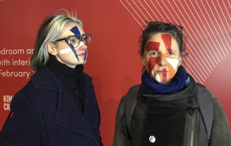 Artists Georgina Rowlands, left, and Anna Hart stand for a photo with their faces painted Feb. 17. They’re two of the four founders of the Dazzle Club, started last year to provoke discussion about the growing using of facial recognition technology.