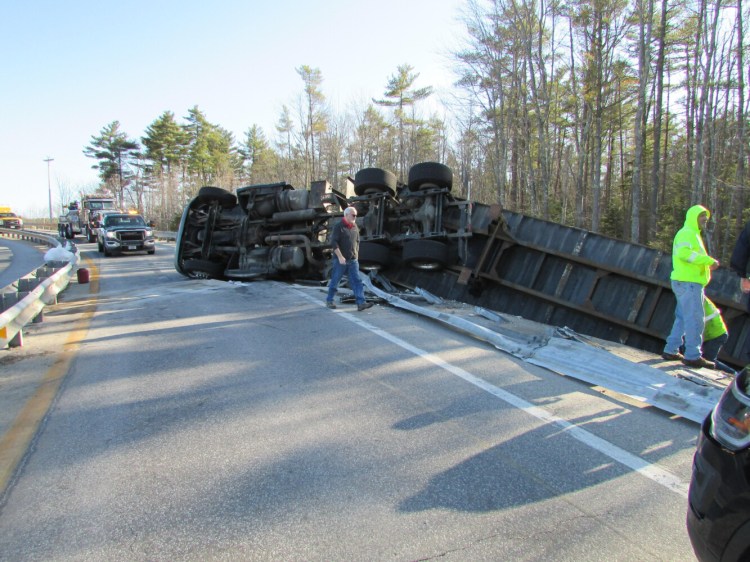 The driver suffered minor injuries when this tractor-trailer overturned on an on-ramp to the Maine Turnpike in Scarborough on Thursday. 
