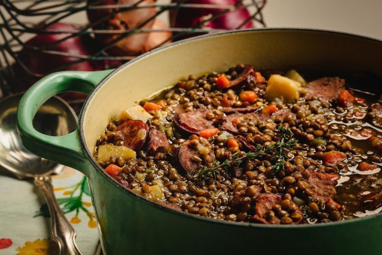 The lentil stew is studded with carrots, potatoes and smoked sausage. 