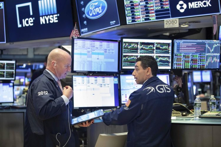 Trader Patrick Casey, left, and specialist Peter Mazza work on the trading floor of the NewYork Stock Exchange on Friday. 