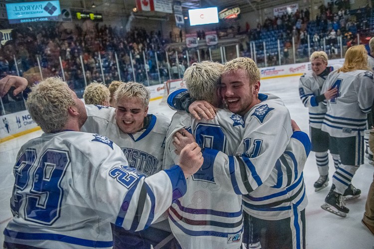 Lewiston players celebrate Saturday night after they capped a 21-0 season with a 2-1 double-overtime victory over Scarborough.
