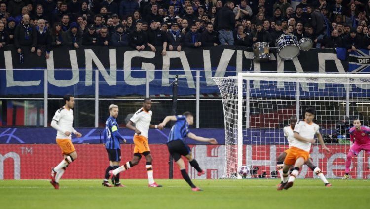 In this Feb. 19 file photo, spectators sit in the stands during the Champions League round of 16, first leg, soccer match between Atalanta and Valencia at the San Siro stadium in Milan, Italy. It was the biggest soccer game in Atalanta’s history and a third of Bergamo’s population made the short trip to Milan’s famed San Siro Stadium to witness it. Nearly 2,500 fans of visiting Spanish club Valencia also traveled to the Champions League match. More than a month later, experts are pointing to the Feb. 19 game as one of the biggest reasons why Bergamo has become one of the epicenters of the coronavirus pandemic — a “biological bomb” was the way one respiratory specialist put it — and why 35% of Valencia’s team became infected. The new coronavirus causes mild or moderate symptoms for most people, but for some, especially older adults and people with existing health problems, it can cause more severe illness or death.