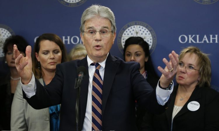 Former U.S. Sen. Tom Coburn speaks at a news conference in Oklahoma City on March 28, 2018. 