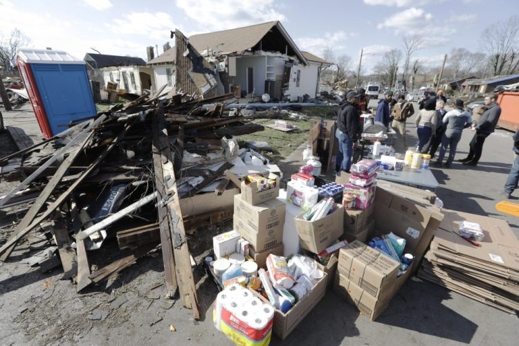 Household supplies are set up at a distribution center next to damaged homes Friday in Nashville. Residents and businesses face a huge cleanup effort after tornadoes hit the state Tuesday. 
