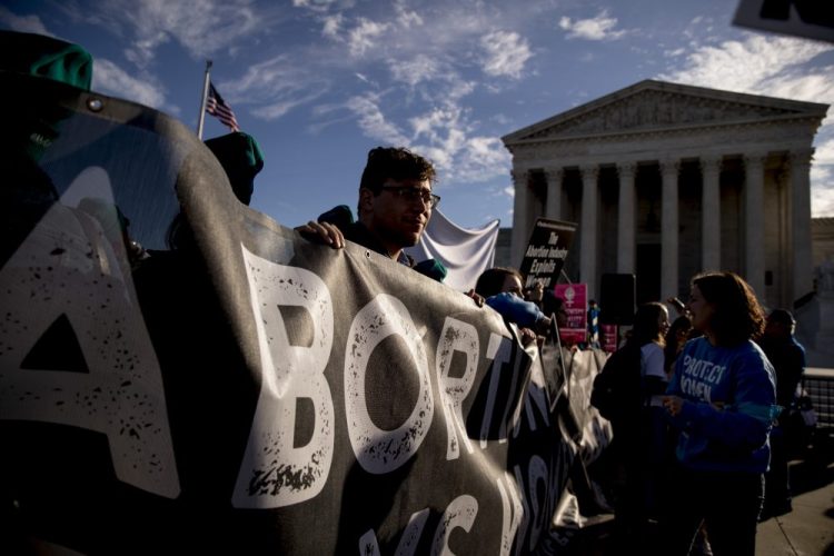 Anti-abortion rights demonstrators rally outside the Supreme Court in Washington on Wednesday as the court takes up the first major abortion case of the Trump era, an election-year look at a Louisiana dispute that could reveal how willing the more conservative court is to roll back abortion rights. 