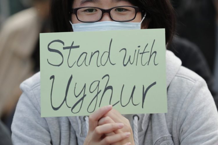 A man shows support for Uighurs and their fight for human rights in Hong Kong on Dec. 22. 