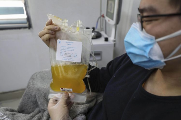 Dr. Zhou Min, a recovered COVID-19 patient who has passed his 14-day quarantine, donates plasma in the city's blood center in Wuhan in central China's Hubei province on Feb. 18. Plasma from recovered COVID-19 patients contains antibodies that may help reduce the viral load in patients that are fighting the disease.