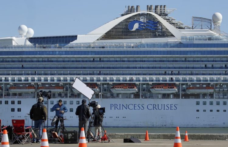 A media crew prepare to film with the Grand Princess cruise ship in the background at the Port of Oakland Thursday, March 12,  in Oakland, Calif. 