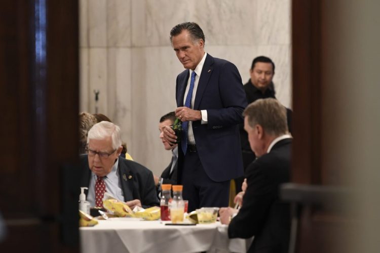 Sen. Mitt Romney, R-Utah, attends a Republican policy lunch Friday on Capitol Hill in Washington to work on sweeping economic rescue plan amid the pandemic crisis and nationwide shutdown that's hurtling the country toward a likely recession.