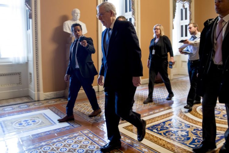 Senate Majority Leader Mitch McConnell of Kentucky arrives on Capitol Hill in Washington on Monday as the Senate is working to pass a coronavirus relief bill. 