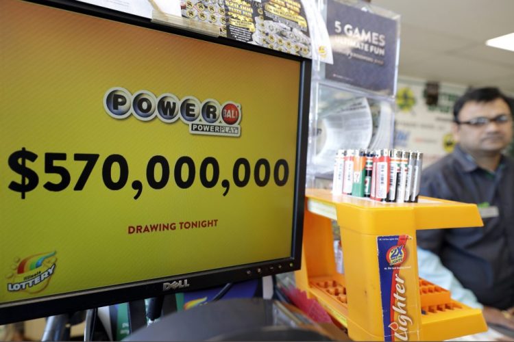 A Powerball lottery sign displays the lottery prizes at a convenience store in Chicago in January 2018. Lottery jackpots are going to shrink as the coronavirus pandemic tamps down lottery sales. 