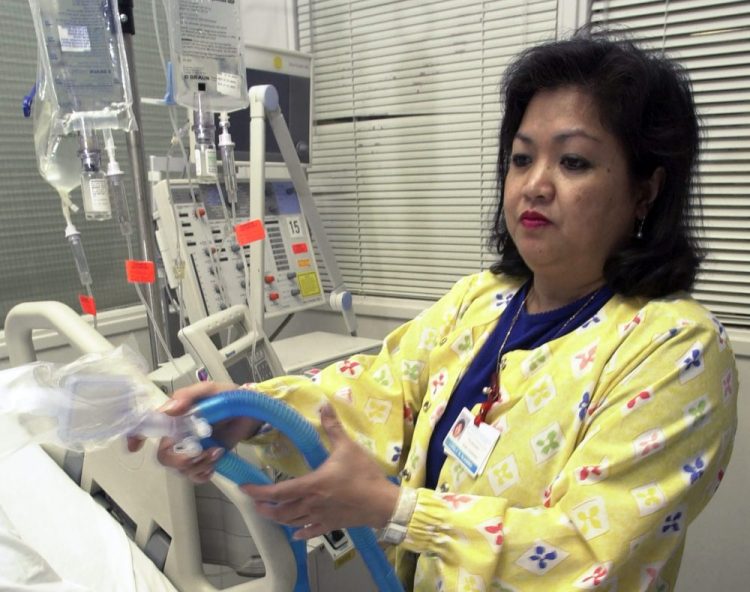 Lovely R. Suanino, a respiratory therapist at Newark Beth Israel Medical Center in Newark, N.J., demonstrates setting up a ventilator in the intensive care unit of the hospital in 2005. U.S. hospitals bracing for a possible onslaught of coronavirus patients with pneumonia and other breathing difficulties could face a critical shortage of ventilators.
