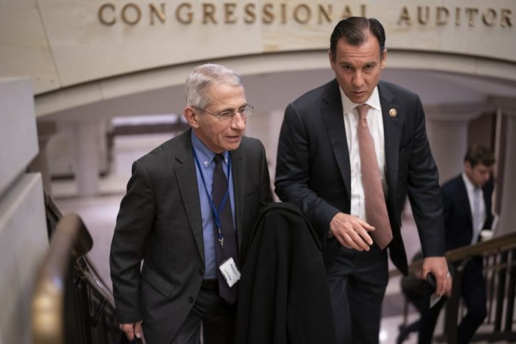 Dr. Anthony Fauci, left, director of the National Institute of Allergy and Infectious Diseases, speaks with Rep. Tom Suozzi, D-N.Y., on Thursday after updating members of Congress on the coronavirus outbreak.