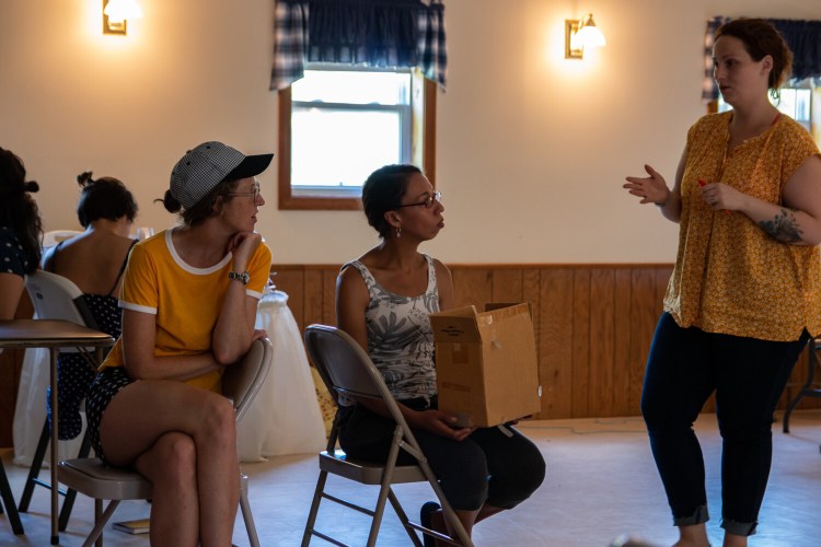 Writer Christina Richardson, middle, listens to company members Kerry Anderson, left, and Tarra Bouchard during a workshop last summer for the play "[Storage]."
