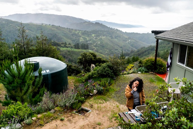 Lisa Pezzino brushes her teeth at her retreat in Big Sur, Calif., 140 miles from her city home in Oakland.
