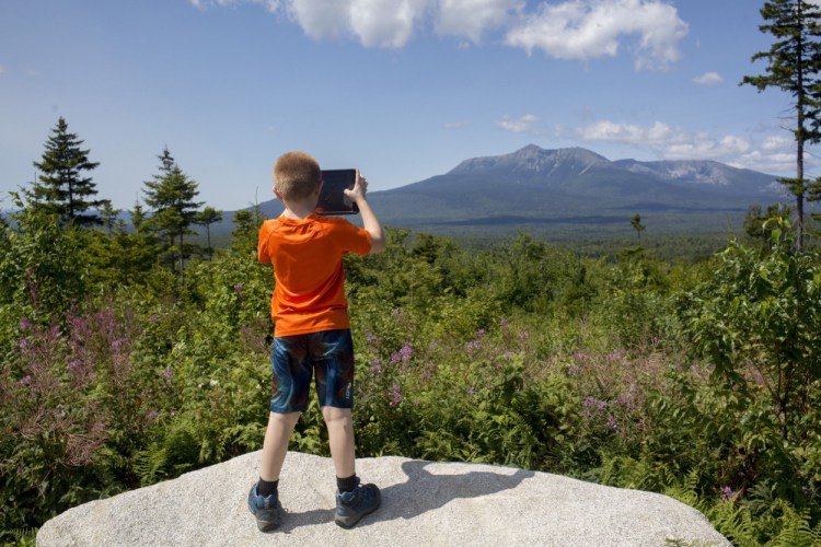 Sean Brady takes a photo of the view from the scenic lookout on the Loop Road in Katahdin Woods and Waters National Monument in 2017. 

