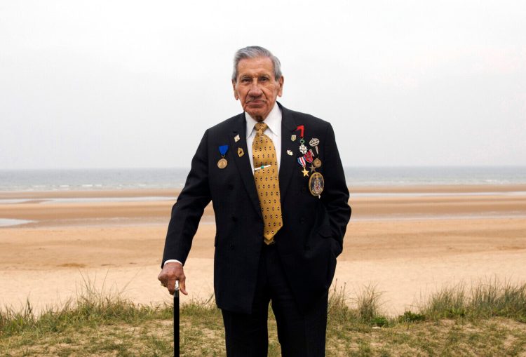 Charles Norman Shay poses on a dune at Omaha Beach in Saint-Laurent-sur-Mer, Normandy, France on May 1, 2019.