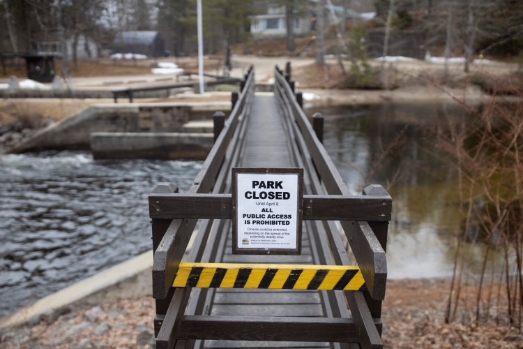 A sign tells visitors that Songo Lock in Casco is closed to visitors Wednesday because of coronavirus. Wednesday marked the traditional opening day of Maine's fishing season.