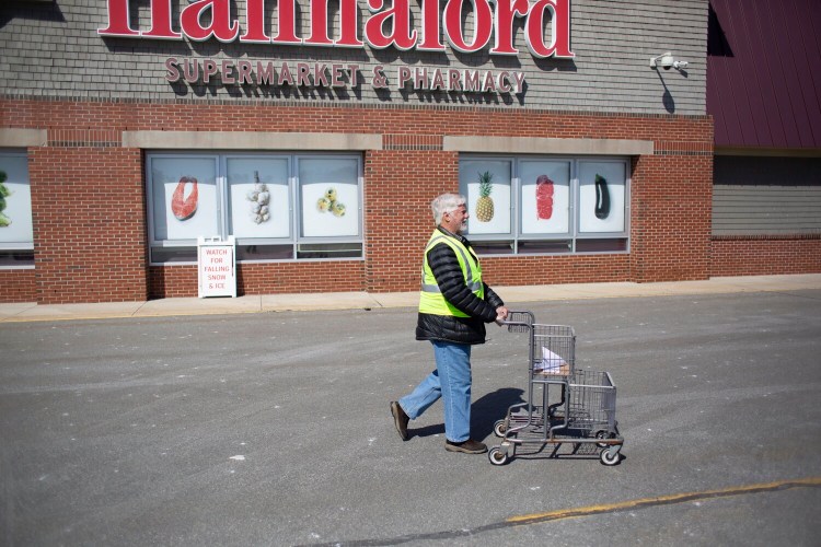 Bill Dunn, a volunteer with The Yarmouth Community Coronavirus Task Force, shops on March 31 for a Yarmouth resident who wasn’t able to go to the store.