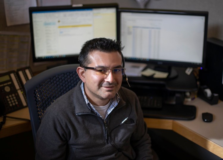 Michael Perez, 34, a senior at the University of Southern Maine, works as a 211 call operator in South Portland. The coronavirus pandemic has reshaped his role. Now, he and other specialists offer callers information such as CDC health guidelines or refer them to the best resources.